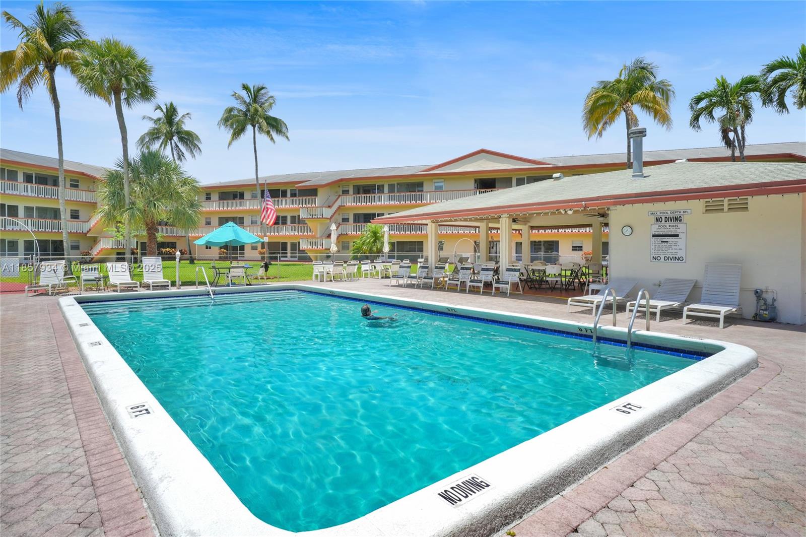 5300 Washington Street, Unit I205 Hollywood, FL 33021 - Photo 16 of 20 a view of swimming pool that has lawn chairs potted plants and palm trees