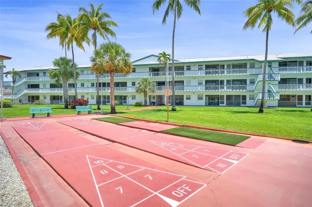 a view of a tall building with a palm trees