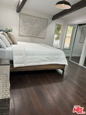 a view of bedroom and bedroom with wooden floor