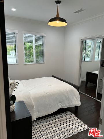 a bedroom with bed and window