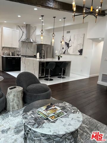 a living room with furniture and kitchen view