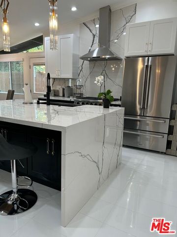 a kitchen with stainless steel appliances a sink and a stove