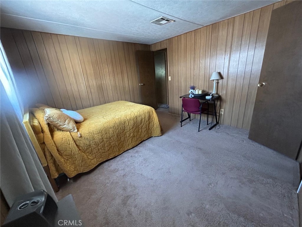 210 Ward Avenue Ridgecrest, CA 93555 - Photo 11 of 19 a bed room with a bed and a chair