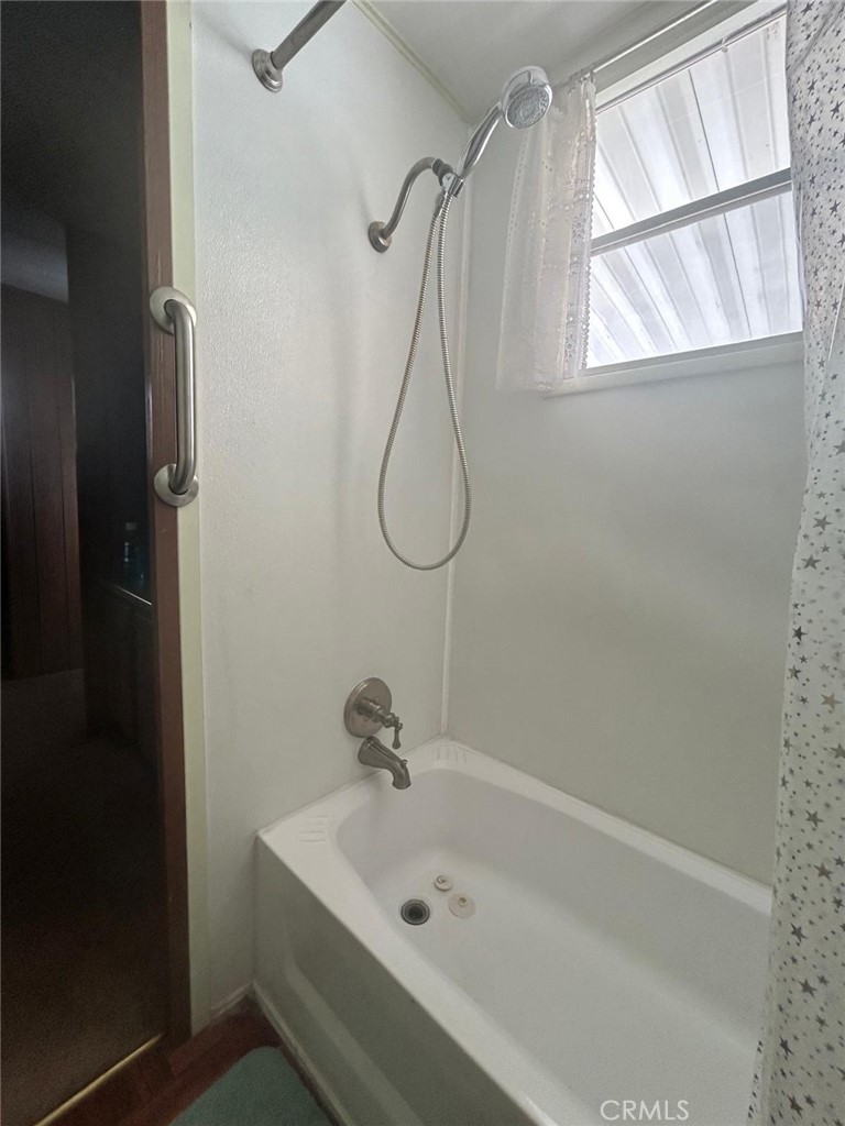 210 Ward Avenue Ridgecrest, CA 93555 - Photo 3 of 19 a bathroom with a bath tub with a shower