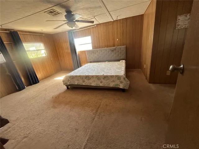 a bedroom with a bed and a mirror