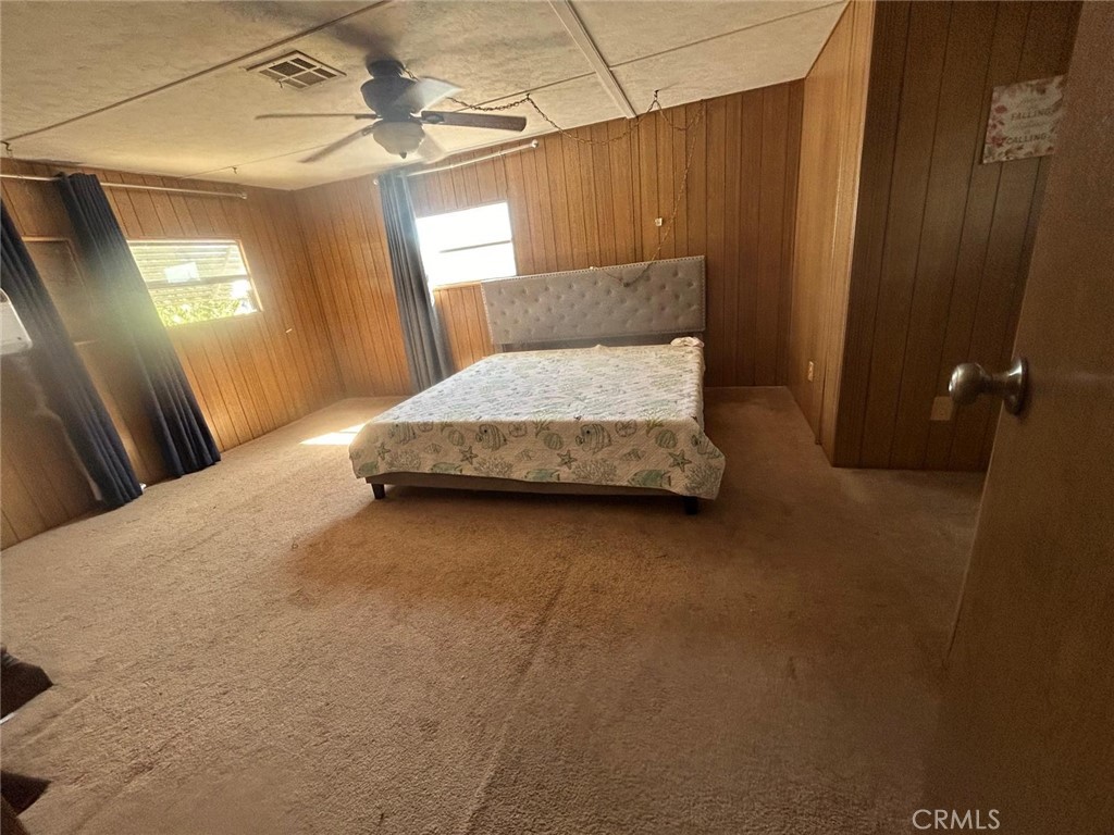 210 Ward Avenue Ridgecrest, CA 93555 - Photo 6 of 19 a bedroom with a bed and a mirror