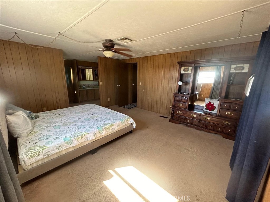 210 Ward Avenue Ridgecrest, CA 93555 - Photo 7 of 19 a bedroom with a large bed and a chandelier