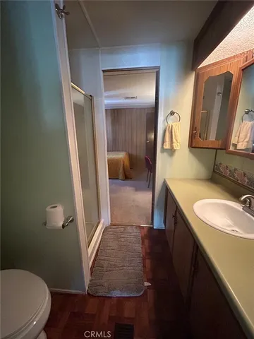 a bathroom with a sink a toilet and vanity