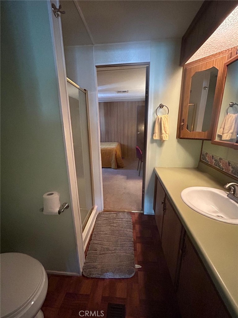 210 Ward Avenue Ridgecrest, CA 93555 - Photo 8 of 19 a bathroom with a sink a toilet and vanity