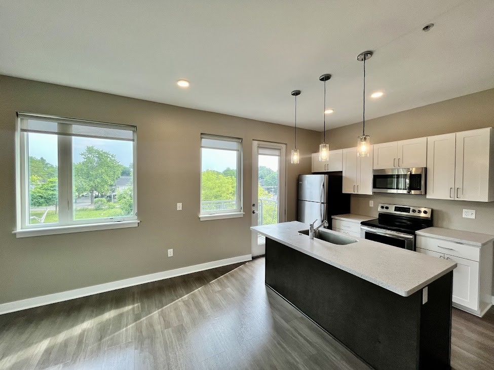 625 South Goodman Street, Unit 311 Rochester, NY 14620 - Photo 2 of 23 Kitchen area of 311 with stainless steel appliances, breakfast bar, and door to balcony