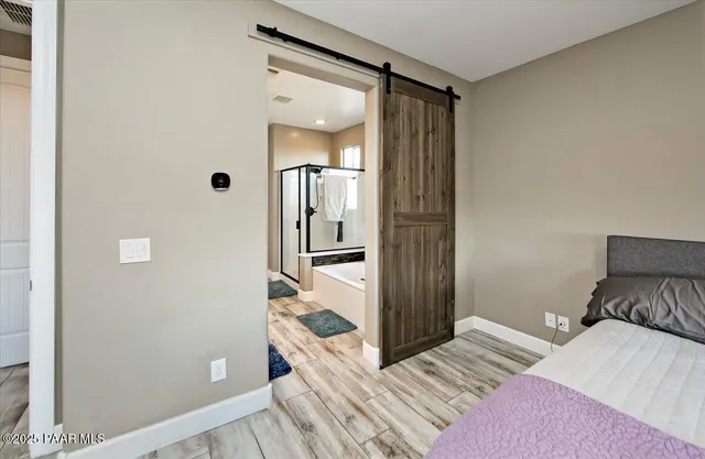 a bedroom with a bed and a mirror