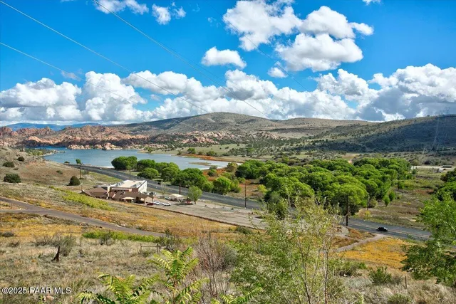 view of a bathroom with a door and wooden floor