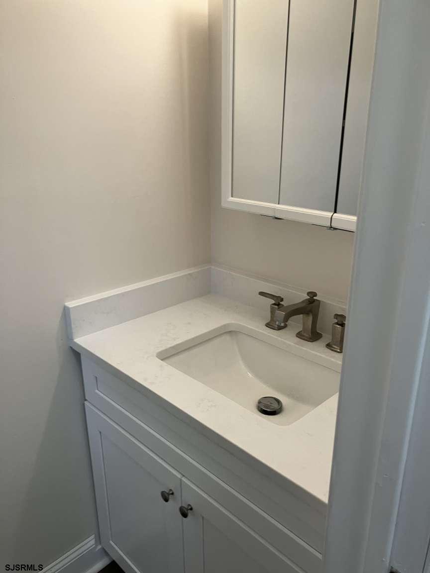 23 Leeds Point Road Galloway Township, NJ 08205 - Photo 17 of 23 a bathroom with a sink and cabinets