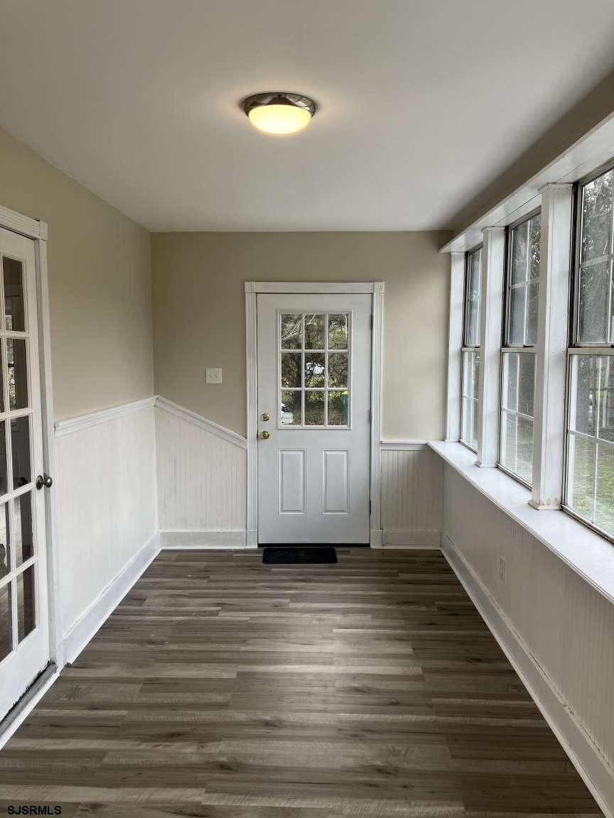 23 Leeds Point Road Galloway Township, NJ 08205 - Photo 9 of 23 a view of an empty room with wooden floor and a window