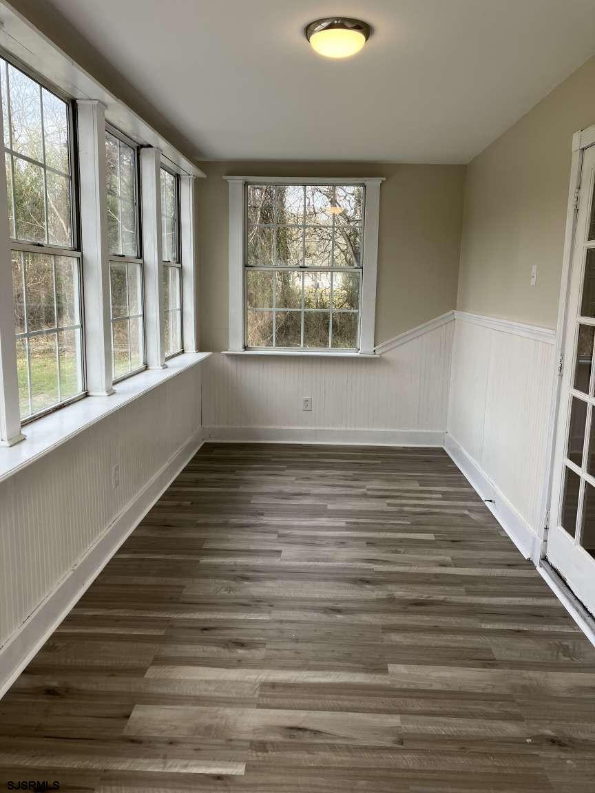 23 Leeds Point Road Galloway Township, NJ 08205 - Photo 10 of 23 a view of empty room with wooden floor and fan
