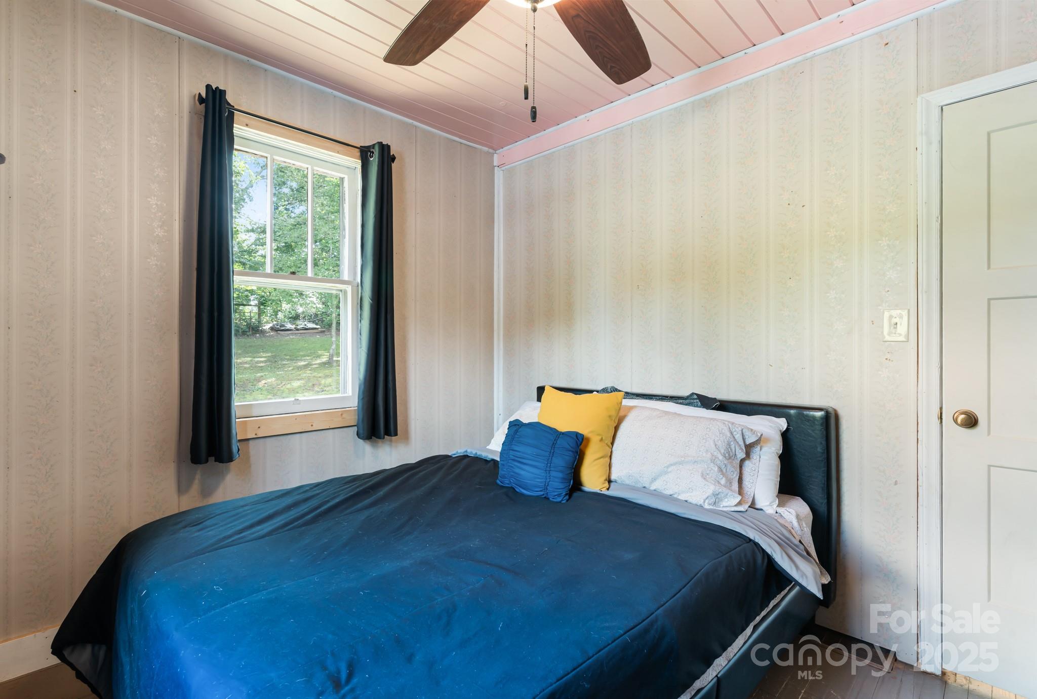 245 Hookers Gap Road Candler, NC 28715 - Photo 11 of 44 a bedroom with a bed and a window
