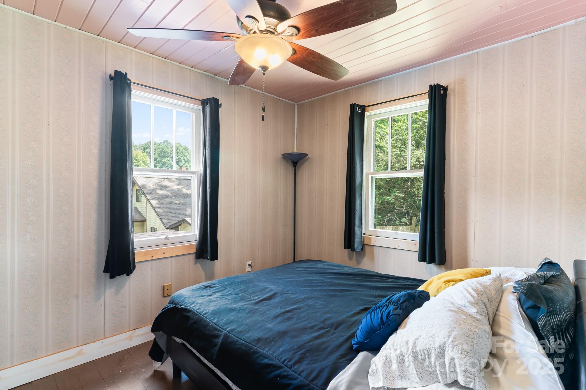 245 Hookers Gap Road Candler, NC 28715 - Photo 12 of 44 a bedroom with a bed and a window