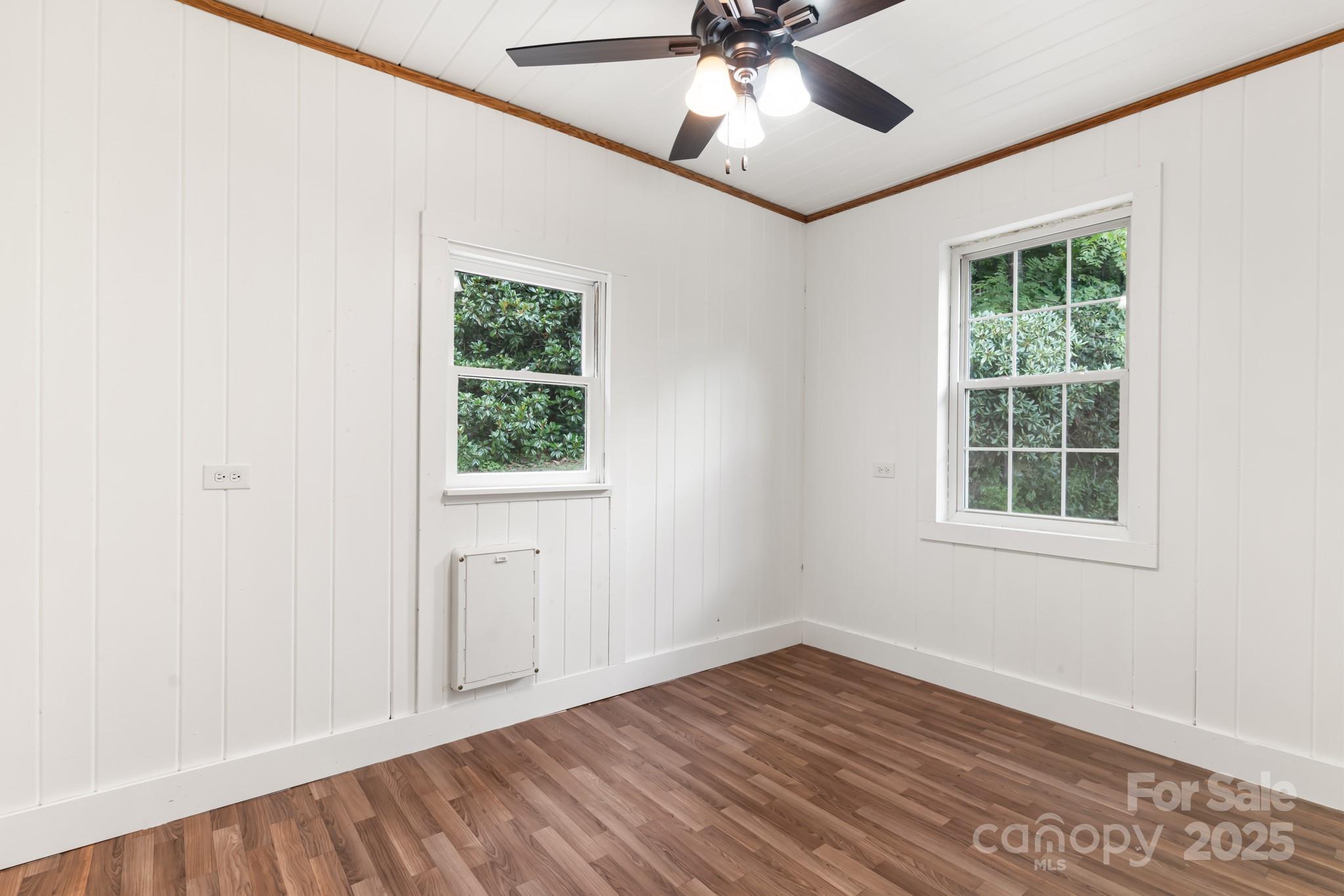 245 Hookers Gap Road Candler, NC 28715 - Photo 15 of 44 an empty room with a window and wooden floor