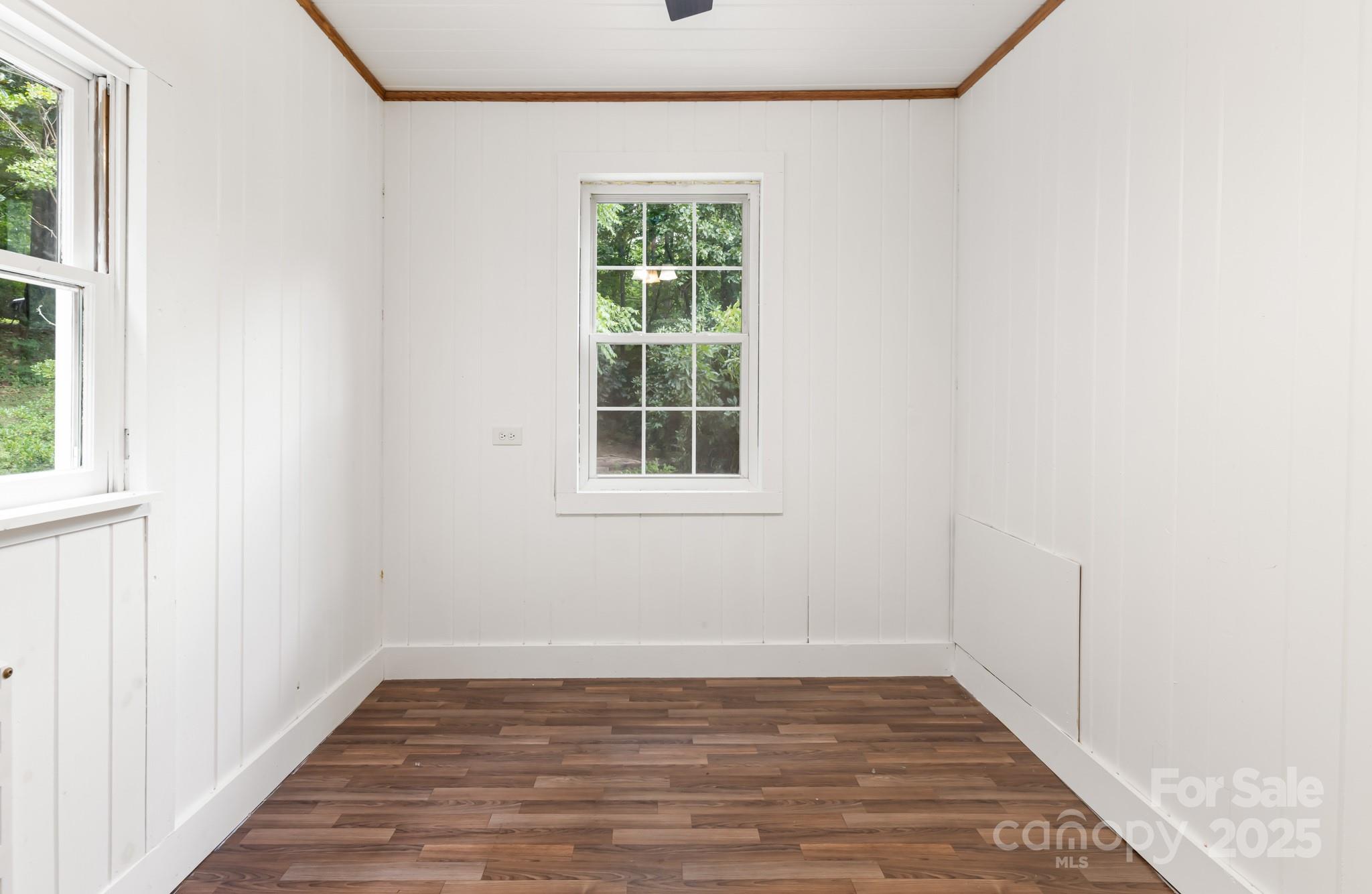 245 Hookers Gap Road Candler, NC 28715 - Photo 16 of 44 an empty room with wooden floor and windows