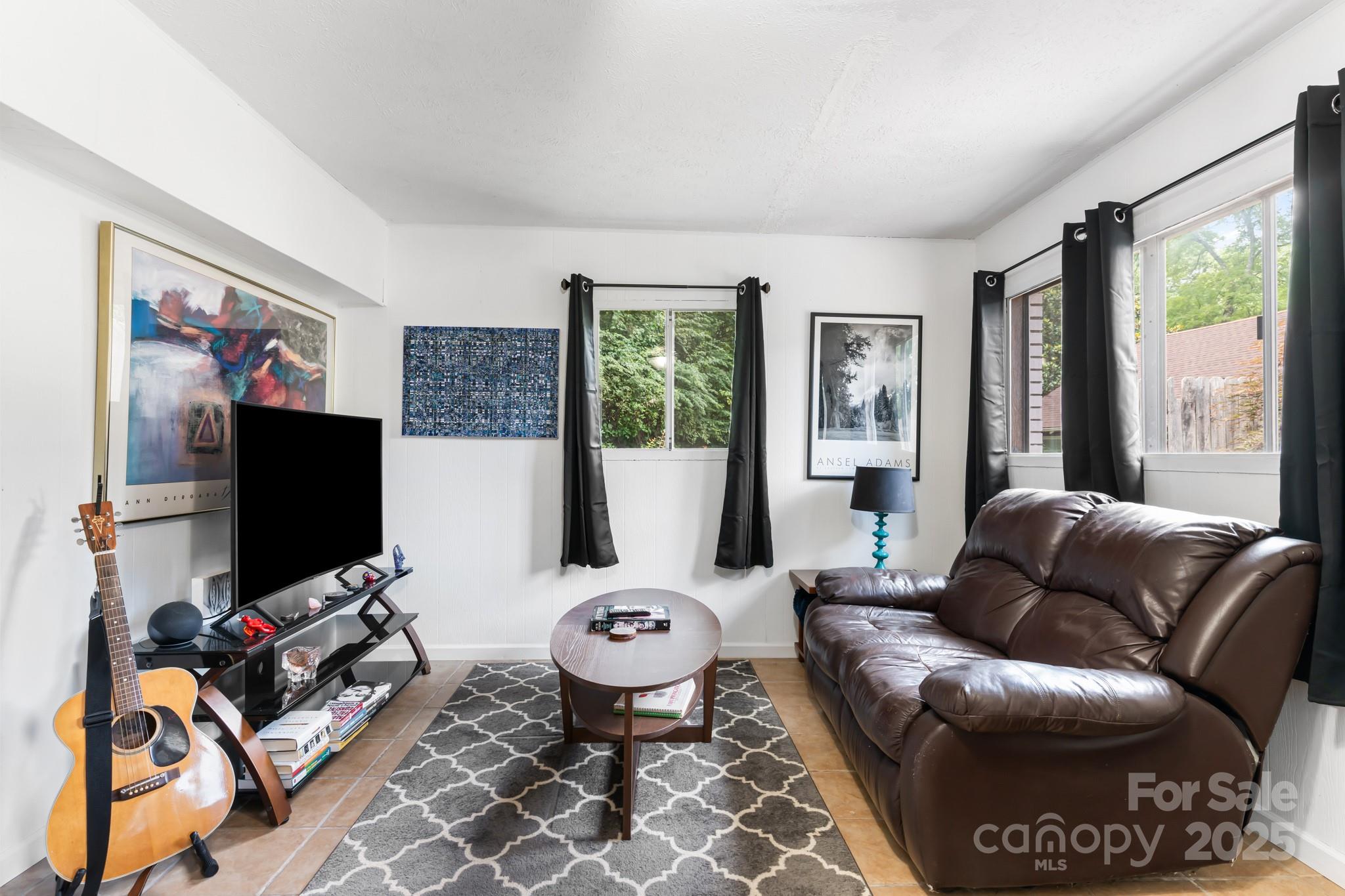 245 Hookers Gap Road Candler, NC 28715 - Photo 18 of 44 a living room with furniture and a flat screen tv