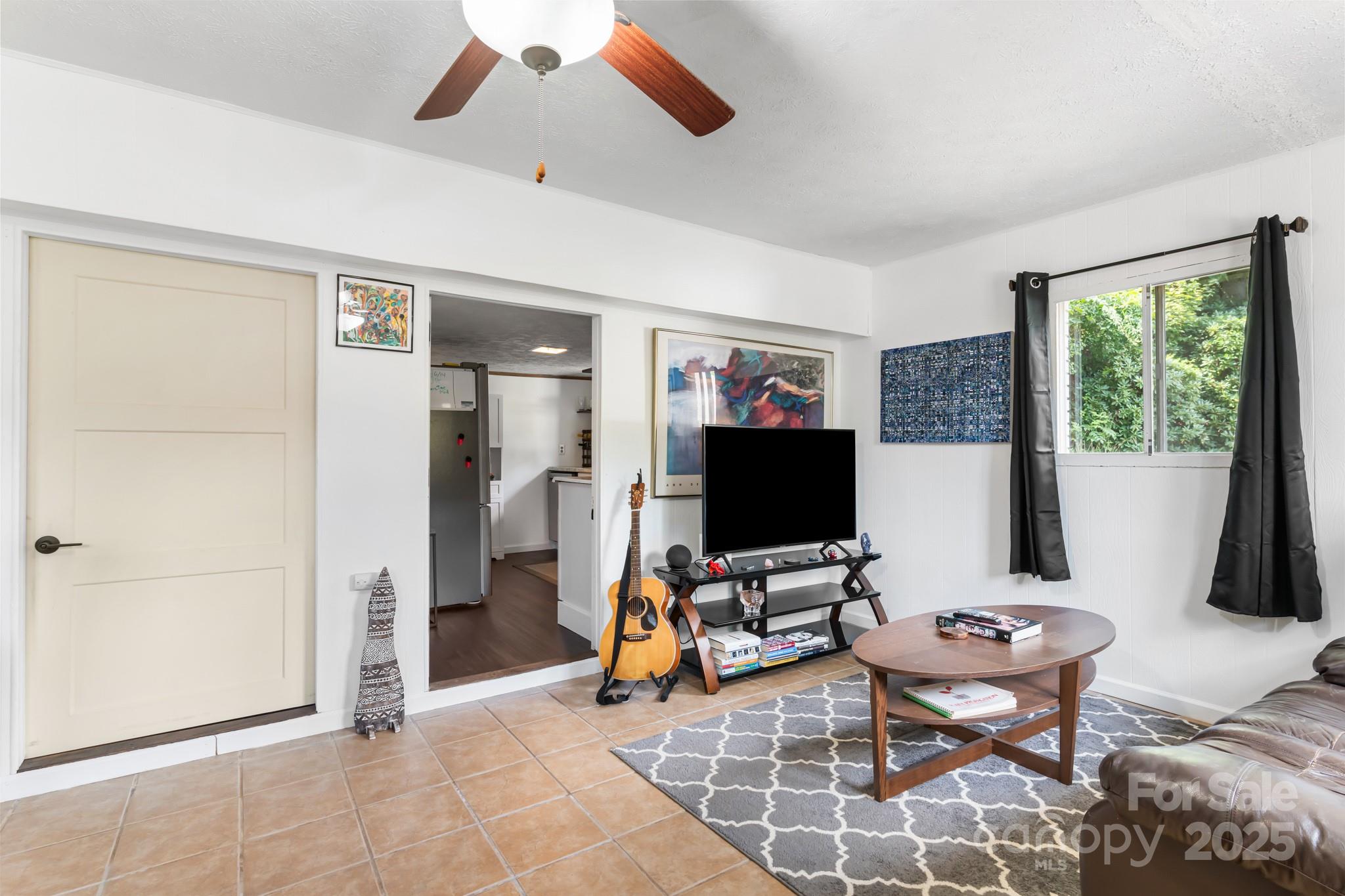 245 Hookers Gap Road Candler, NC 28715 - Photo 20 of 44 a view of a livingroom with workspace and a window