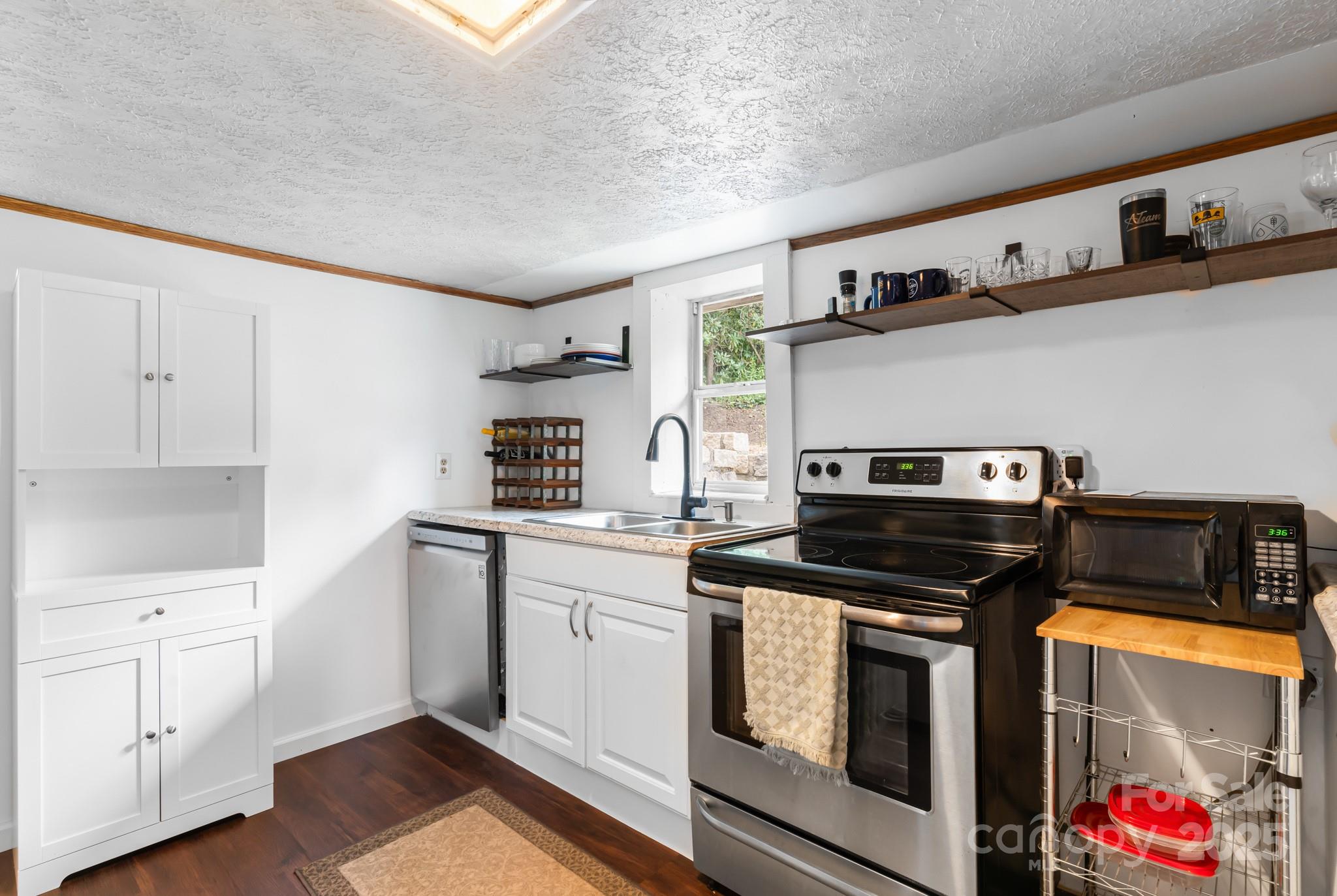 245 Hookers Gap Road Candler, NC 28715 - Photo 25 of 44 a kitchen with cabinets and appliances
