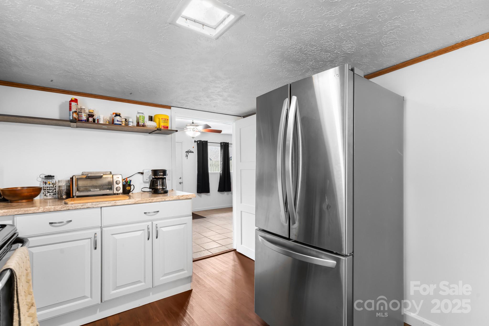 245 Hookers Gap Road Candler, NC 28715 - Photo 26 of 44 a kitchen with stainless steel appliances a refrigerator sink and cabinets