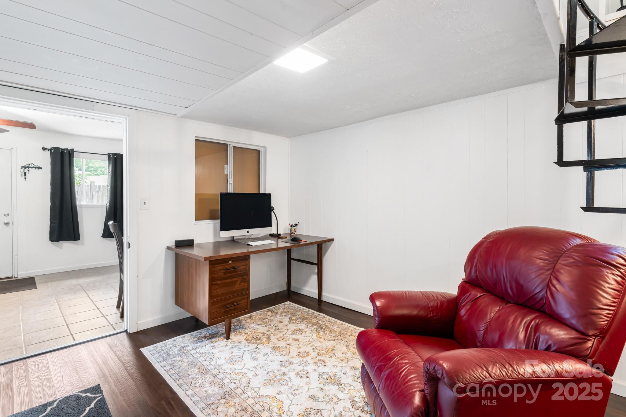 245 Hookers Gap Road Candler, NC 28715 - Photo 27 of 44 a living room with furniture and a flat screen tv