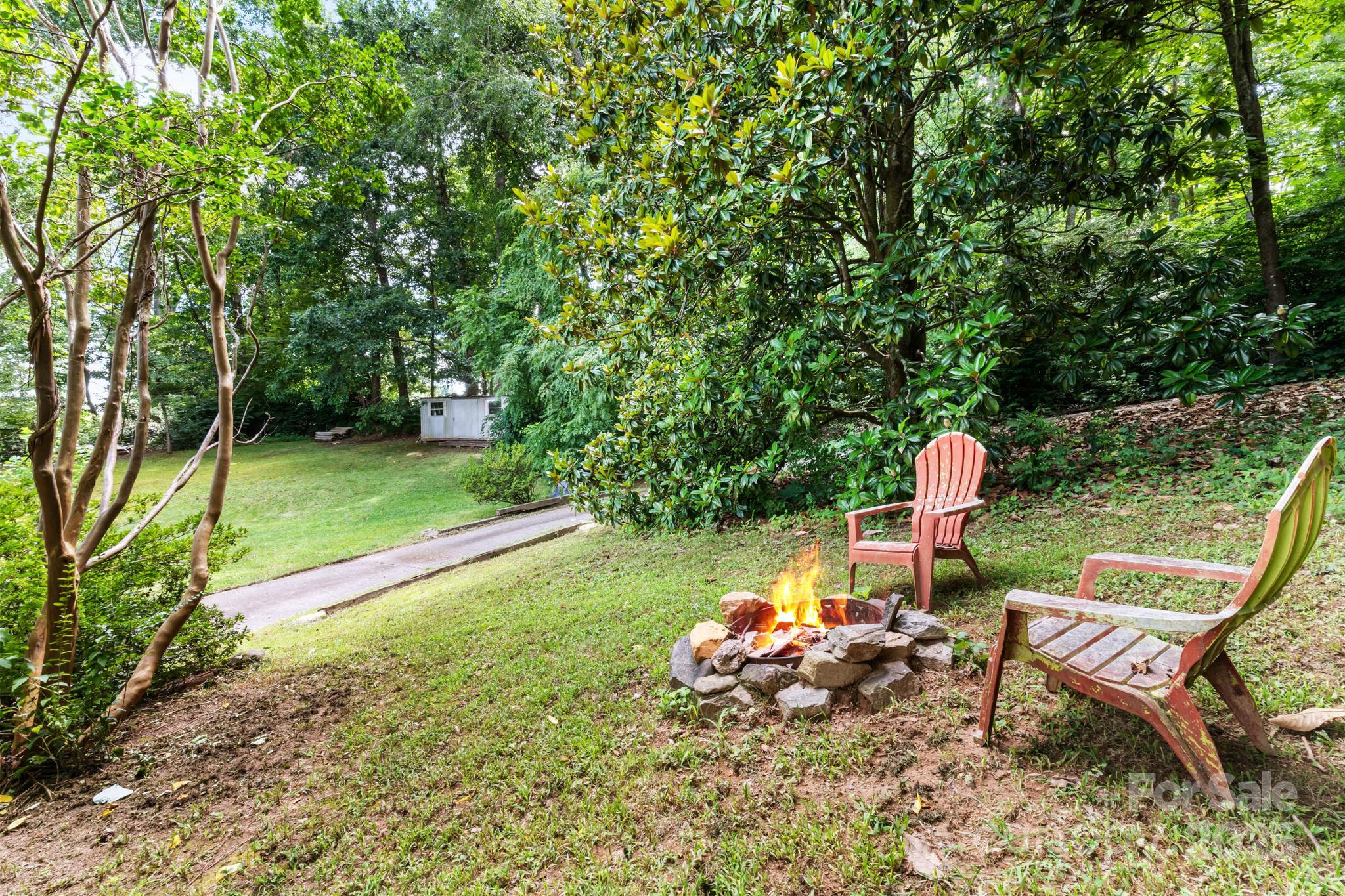 245 Hookers Gap Road Candler, NC 28715 - Photo 31 of 44 a view of a bench in a garden