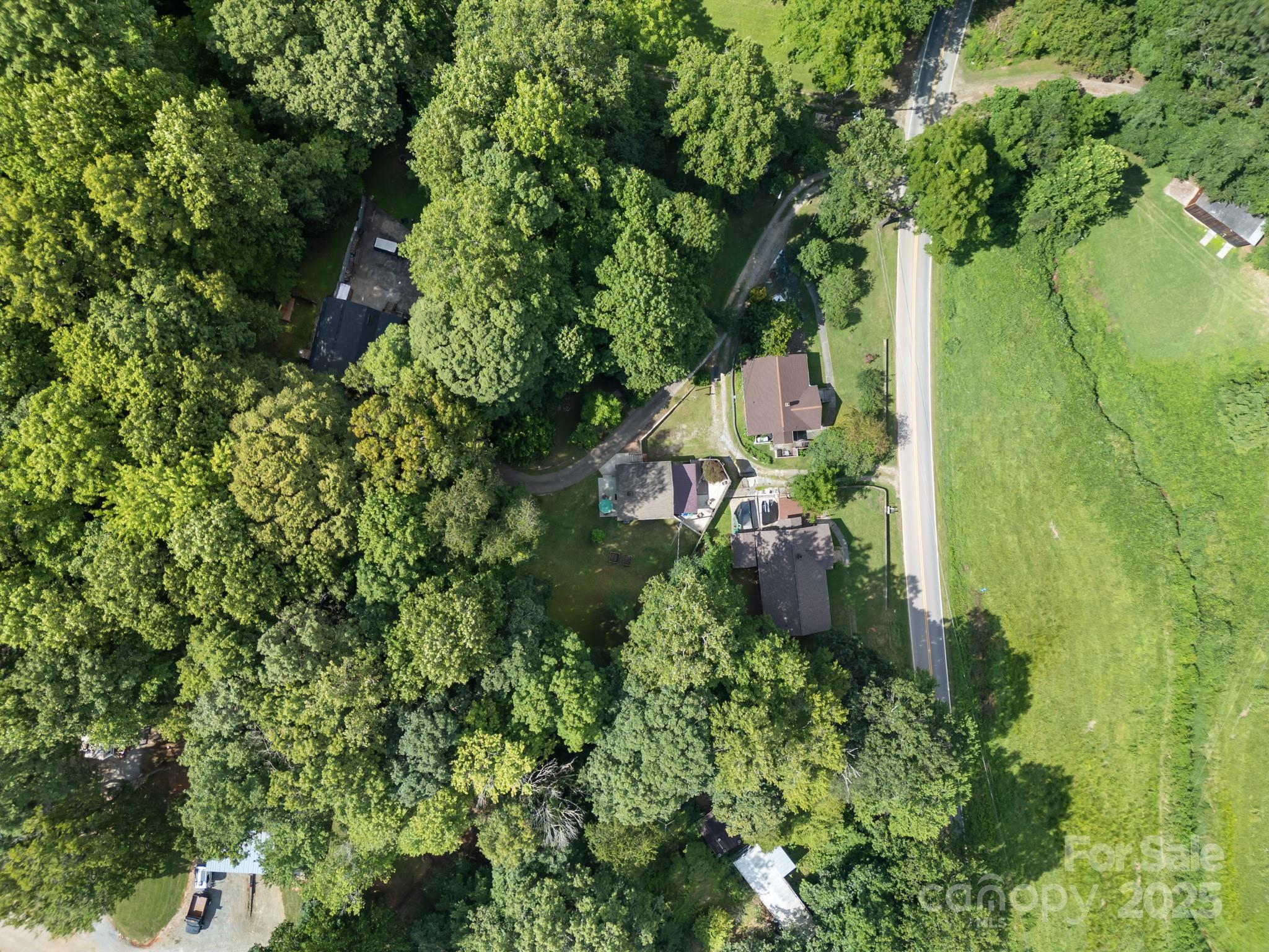 245 Hookers Gap Road Candler, NC 28715 - Photo 40 of 44 an aerial view of a house with swimming pool and garden