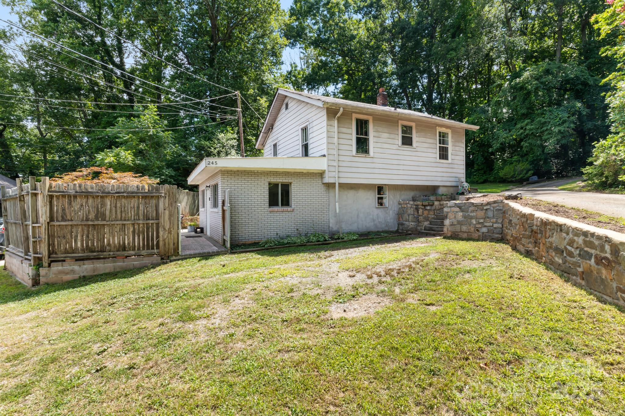 245 Hookers Gap Road Candler, NC 28715 - Photo 4 of 44 a view of a house with a yard and large tree