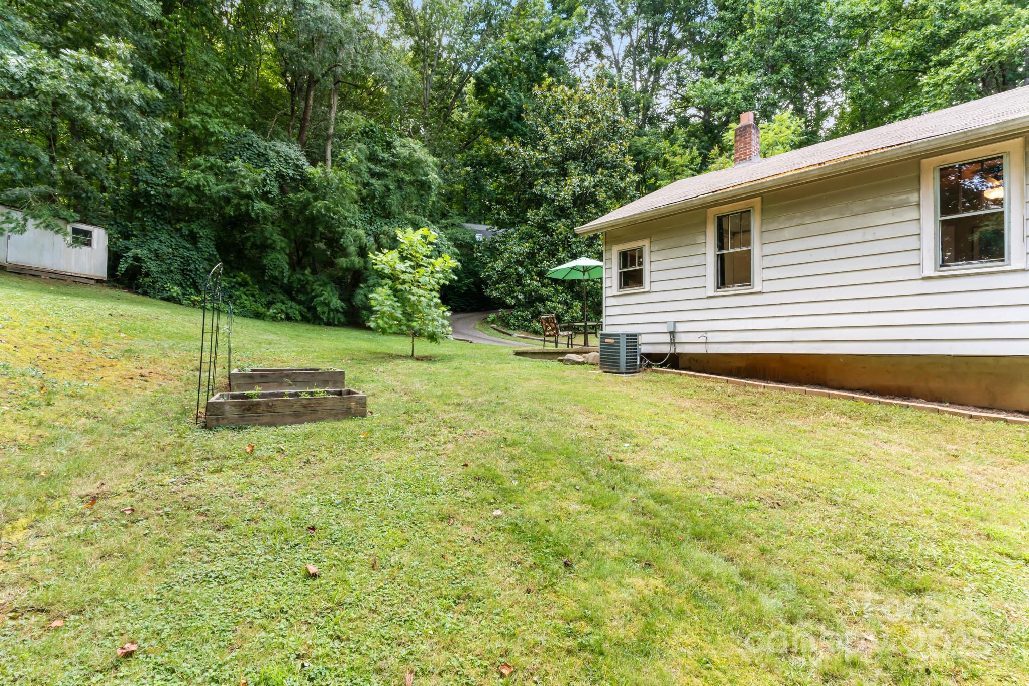 245 Hookers Gap Road Candler, NC 28715 - Photo 6 of 44 a backyard of a house with yard and trampoline