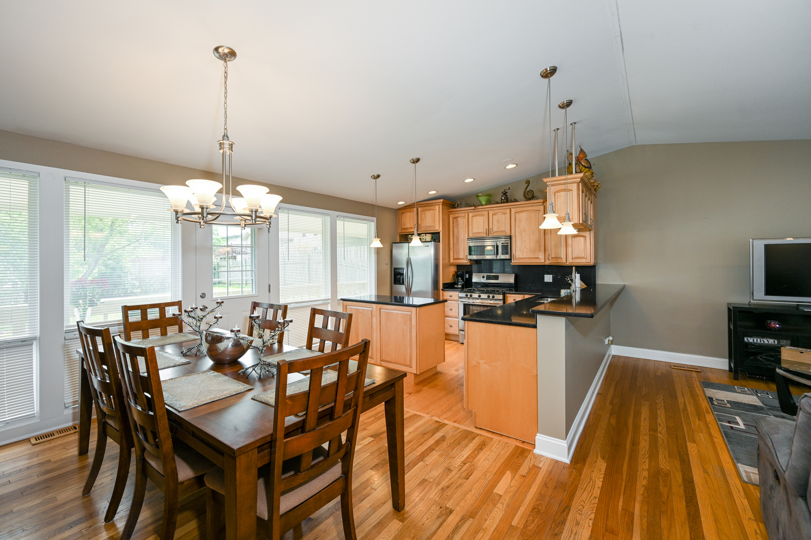 2S655 Bob O Link Road Lombard, IL 60148 - Photo 8 of 28 a view of a dining room and livingroom with furniture wooden floor a chandelier