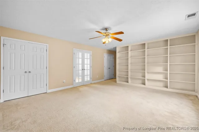 an empty room with a empty shelves and natural light