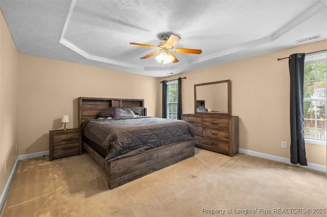 a bedroom with a large bed and a chandelier