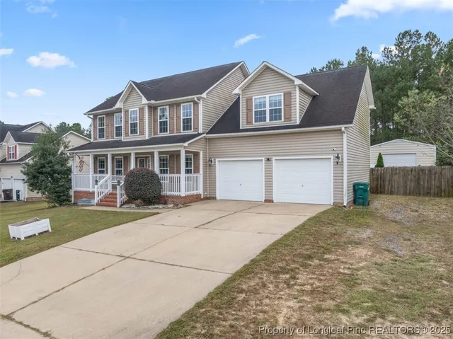 a front view of a house with a garden and yard