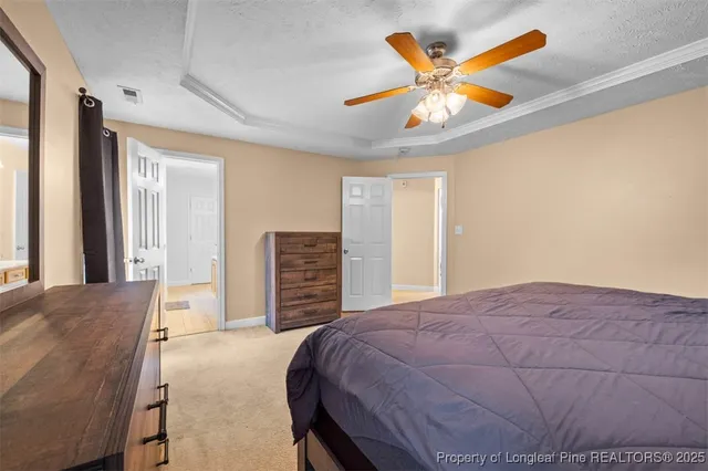 a bedroom with a bed and ceiling fan