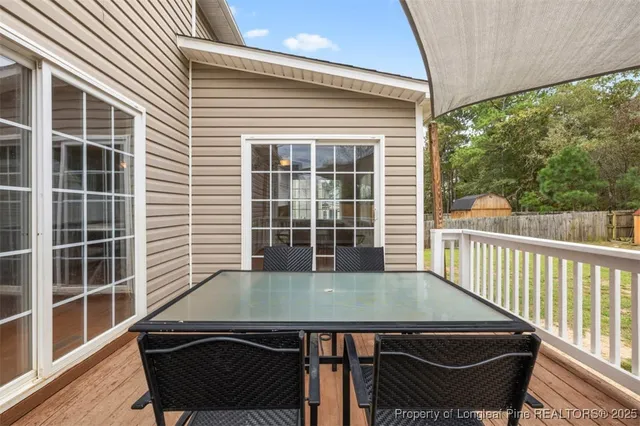 a view of a balcony with a table and chairs