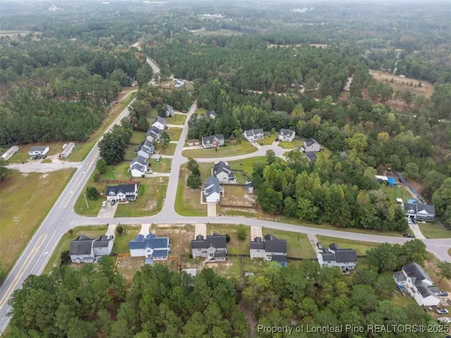 an aerial view of a house with swimming pool outdoor seating and yard