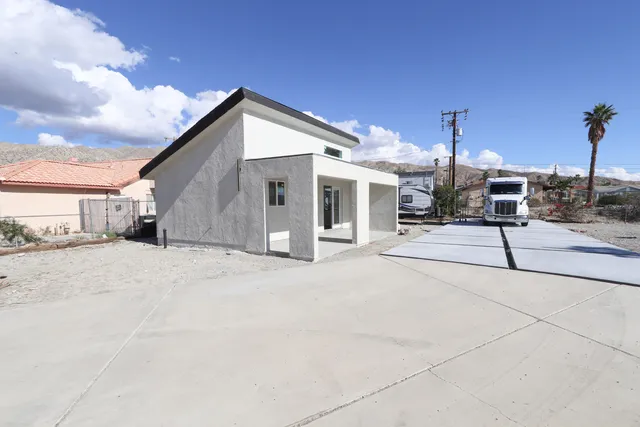 a patio with a table and chairs