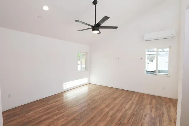 wooden floor in an empty room with a window