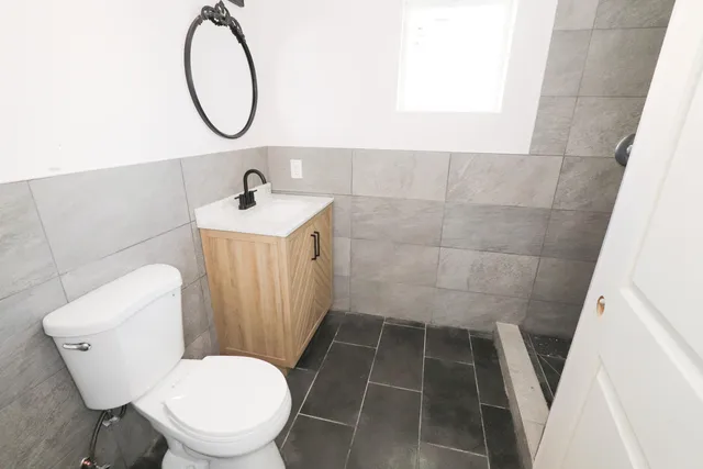 a bathroom with a sink toilet and a mirror