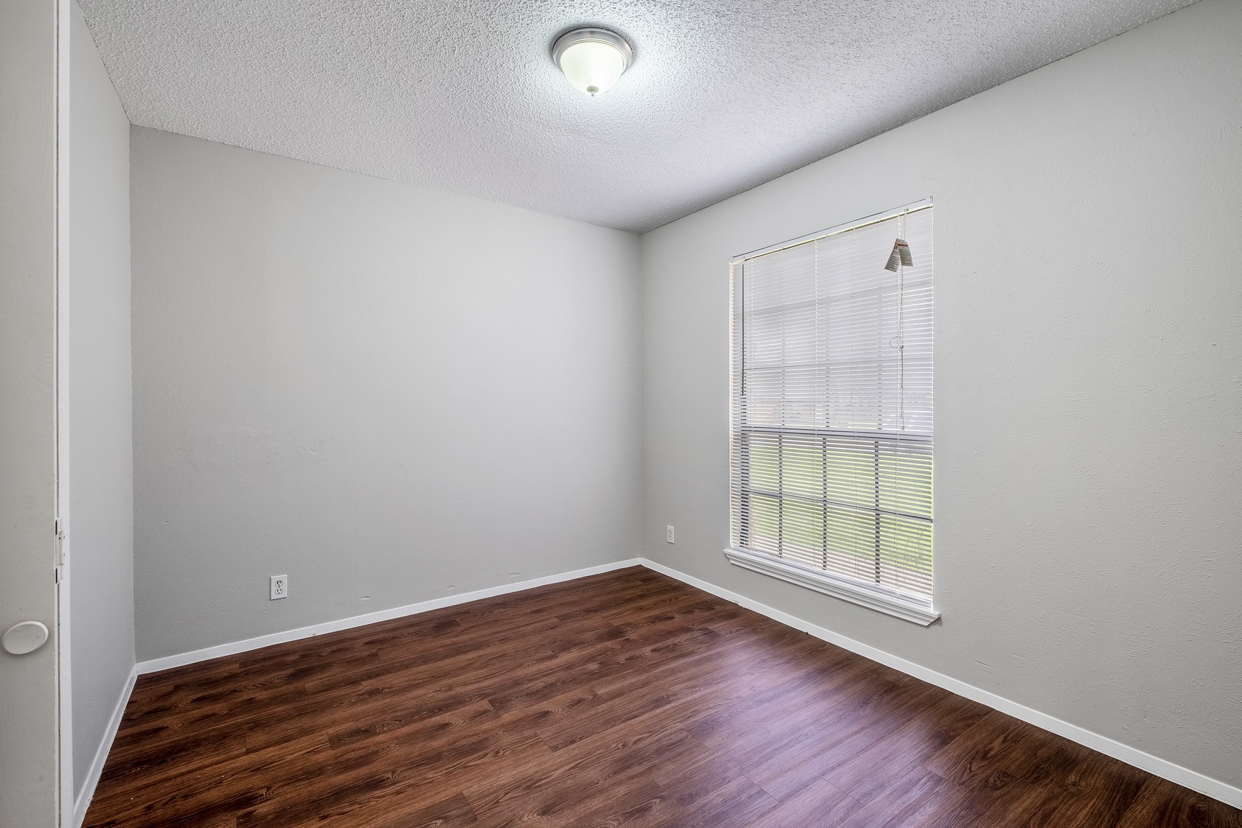 604 Misty Morning Way, Unit B Round Rock, TX 78664 - Photo 11 of 23 an empty room with wooden floor and windows