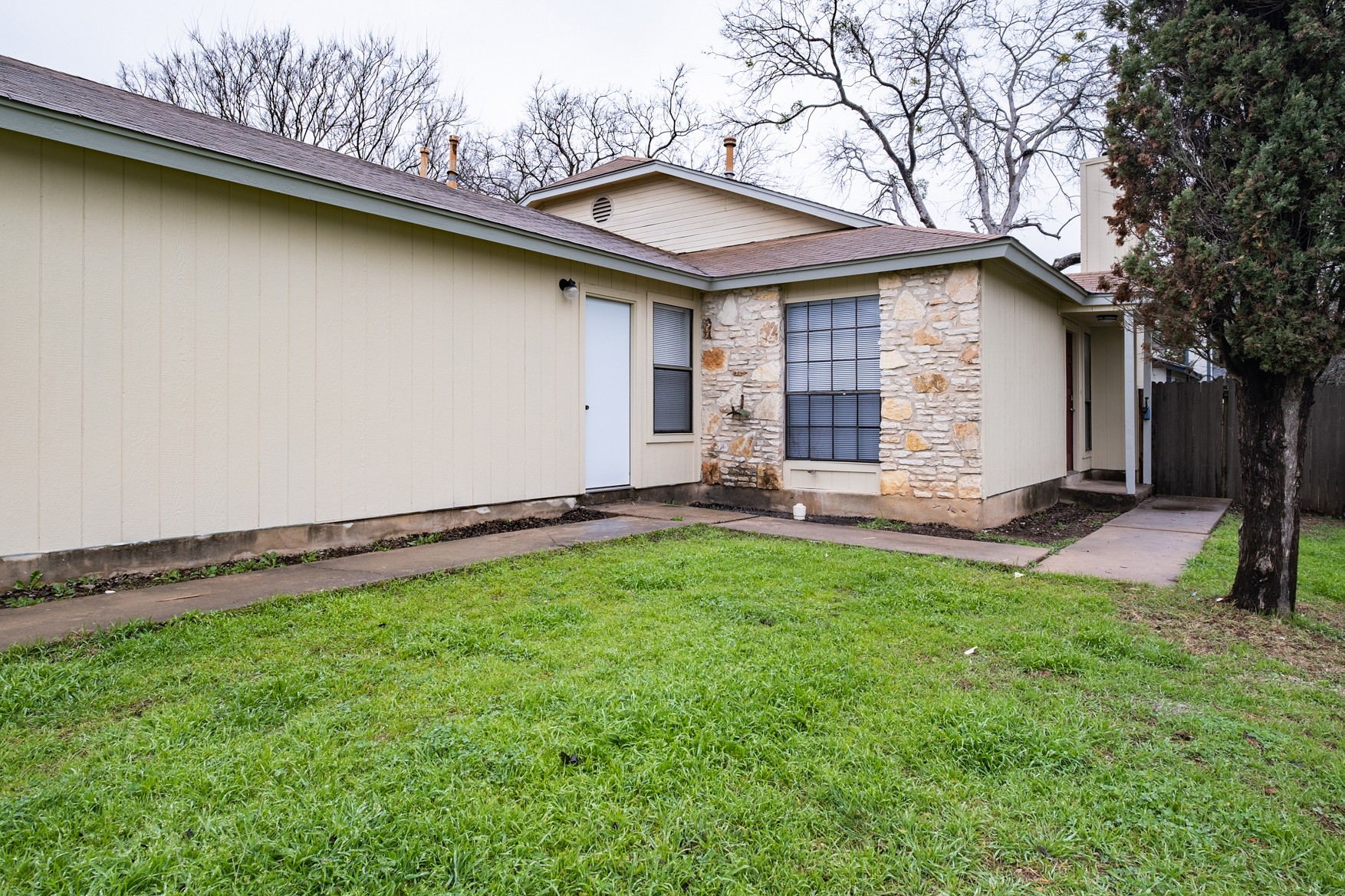 604 Misty Morning Way, Unit B Round Rock, TX 78664 - Photo 21 of 23 a backyard of a house with lots of green space