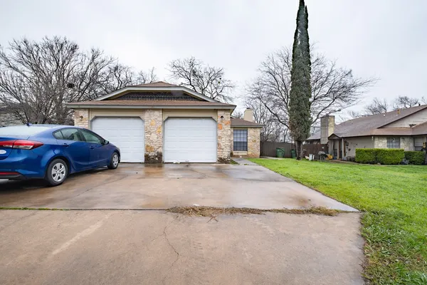 a view of a car parked in front of a house