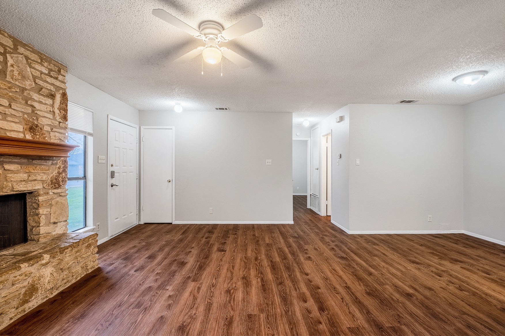 604 Misty Morning Way, Unit B Round Rock, TX 78664 - Photo 3 of 23 a view of empty room with wooden floor and fireplace