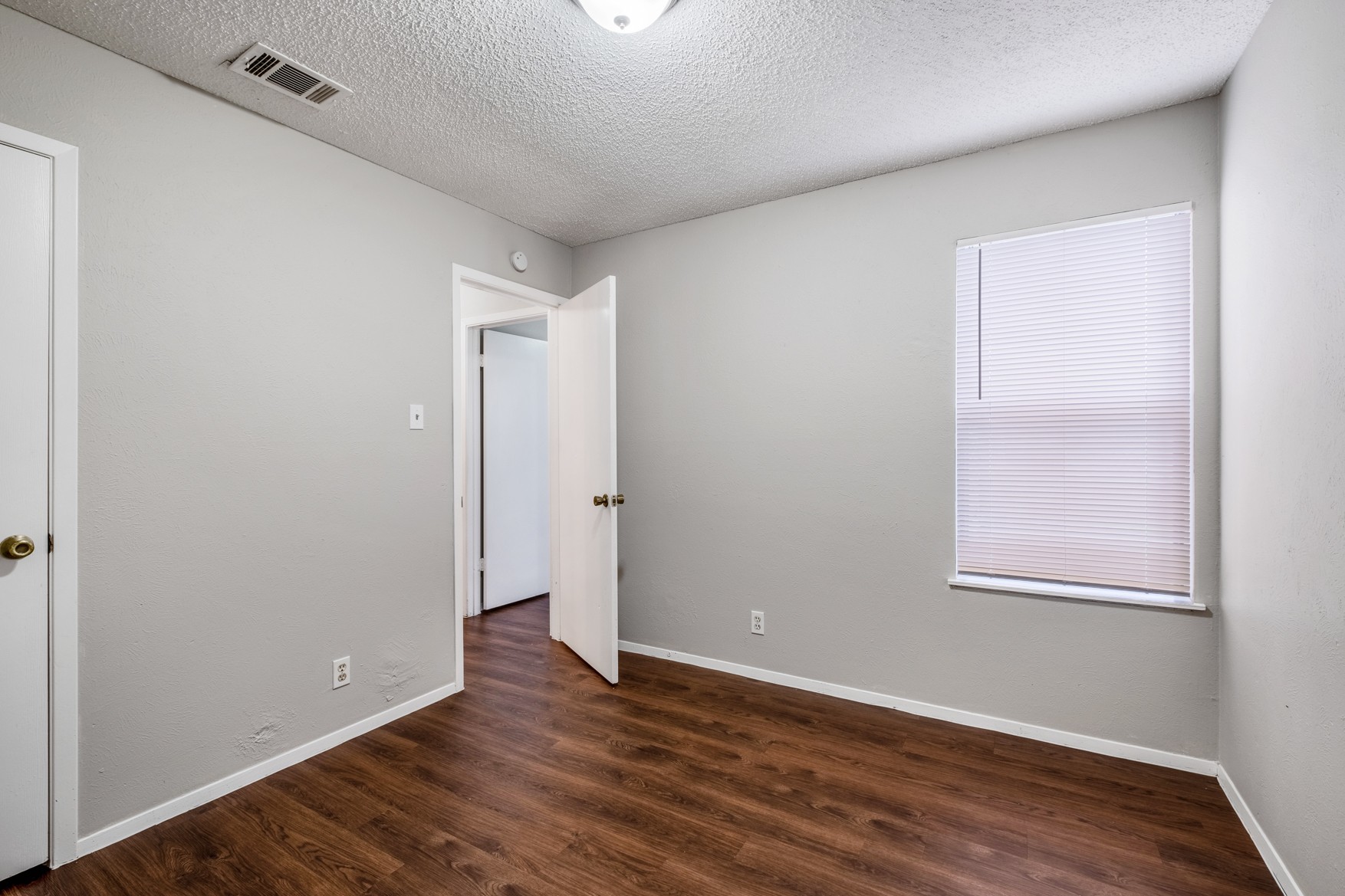 604 Misty Morning Way, Unit B Round Rock, TX 78664 - Photo 10 of 23 an empty room with wooden floor and windows