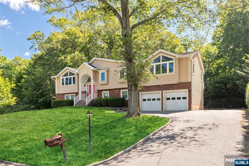 21 Marcia Road Ringwood, NJ 07456 - Photo 39 of 42 a front view of a house with a yard and garage