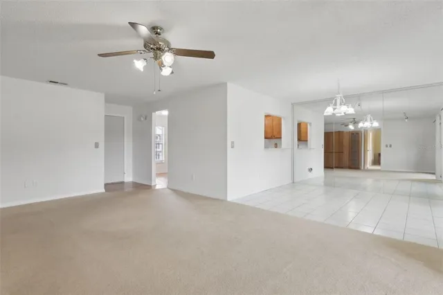 a view of an empty room with a ceiling fan
