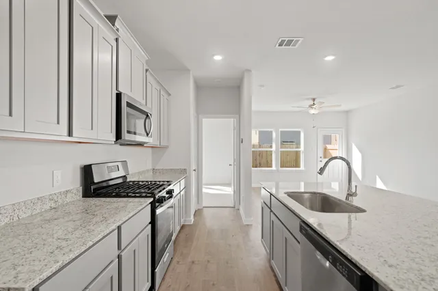 a kitchen that has a sink and a stove